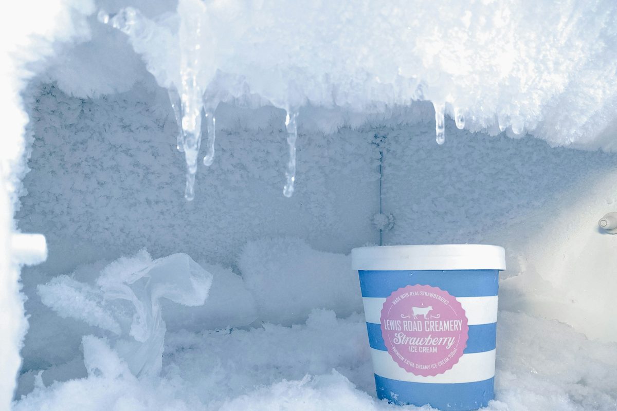 Heavy frost and ice buildup inside a freezer compartment